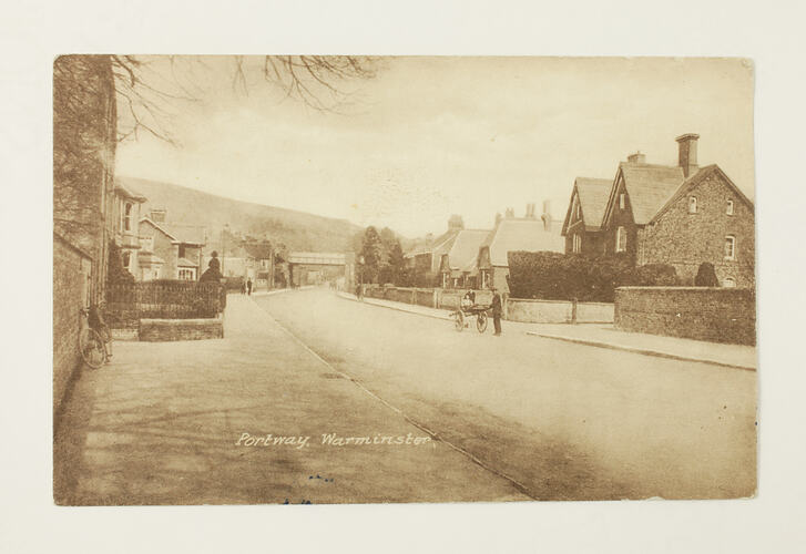 Front of postcard with photo of village.