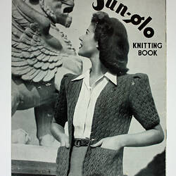 Knitting book cover showing woman wearing cardigan with winged lion.