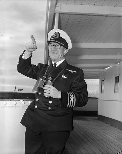 Portrait of man in naval uniform on ship.