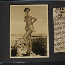 Album page with photograph, black and white, woman posing in polka dot bikini, standing. Newspaper article.