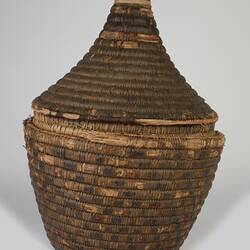 Woven fibre round basket with conical lid.