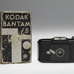 Black bakelite camera with cardboard box.