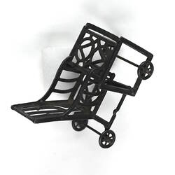 High chair converted to chair and table, angled view.