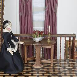 Doll's house interior room. Furnished and featuring costumed figures.