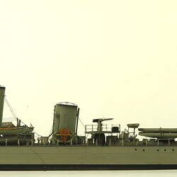 Grey coloured naval ship, facing left.