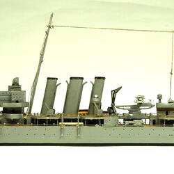 Naval ship with two masts, facing left.