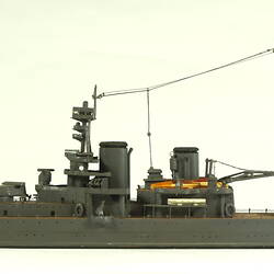 Naval ship with two masts, facing left.