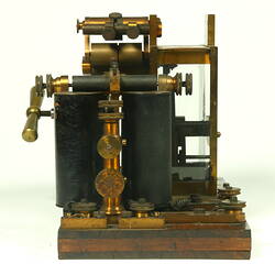 Brass apparatus on wooden base.