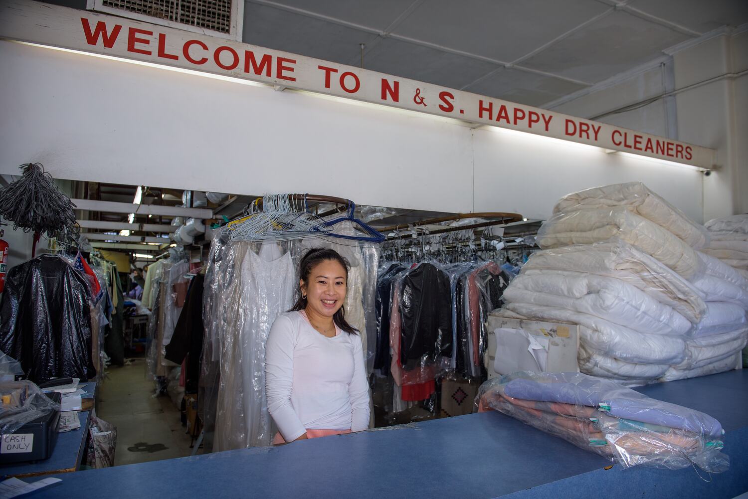Digital Photograph Owner of DryCleaning Business at Work During