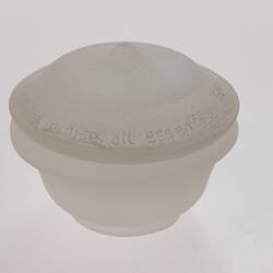 Opaque glass round spice container with lid. Narrower at base.