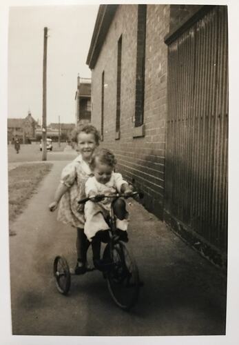 Photograph - Kay & James Morgan Riding a Tricycle, South Melbourne, circa 1943