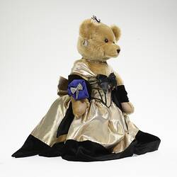 Profile, light brown bear in black velvet and gold lame gown. Faux diamond, amethyst tiara, necklace, earrings