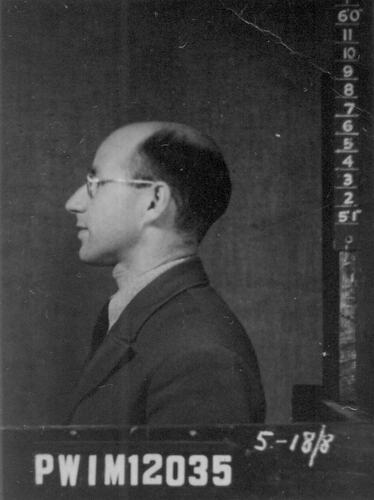Profile of man. He wears a dark tie and jacket with a pale shirt. Numbers at right side and bottom.