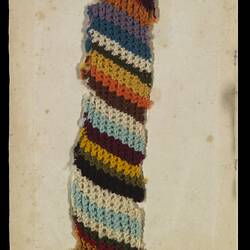 Page 13 of an unbound book containing a knitting sample. Multi coloured spiral tube.