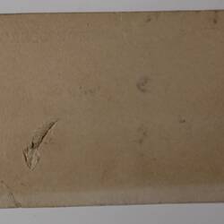 Back of off-white rectangular label.
