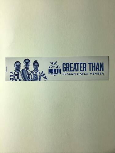 White strip sticker with 3 female footballers and blue text.