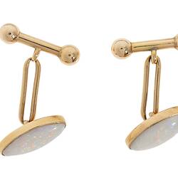 Gold clip cufflinks, each with an oval white opal.