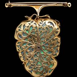 Gold filigree back of white opal, gold and silver brooch in the shape of a flower.