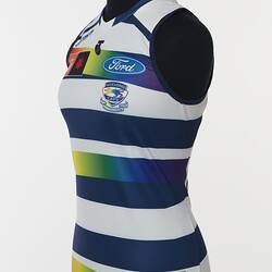 Women's AFLW guernsey with horizontal navy, white and rainbow stripes. Three quarter front left view.