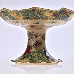 Cream coloured compote with wavy edges decorated with birds & chrysanthemums.