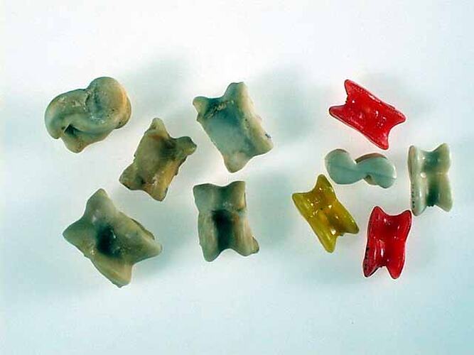 Two sets of knucklebones, real and plastic.