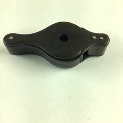 Black loupe, closed. Two round hinged magnifying glasses have be slid into the case.