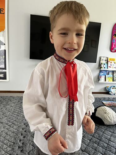 Boy wearing a traditional Ukrainian white and red shirt.