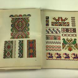Open folder with colourful printed geometric embroidery designs.