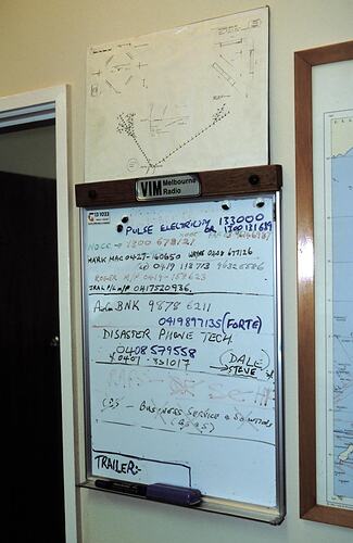 Wall-mounted white board, with messages. Melbourne Coastal Radio Station, Cape Schanck, Victoria