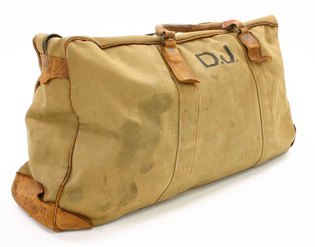 Canvas luggage bag with initials DJ printed on it.