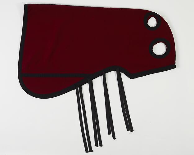 Red and black woollen horse hood. Four straps. Two cut out holes.