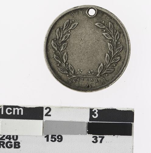 Round medal with wreath.