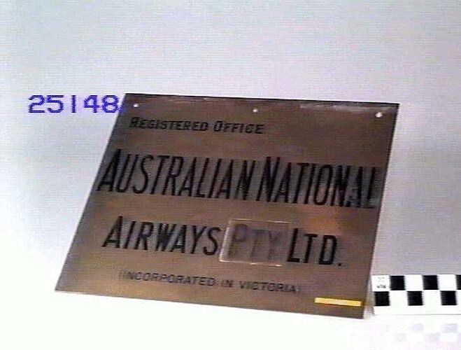 Brass plaque with printed words.