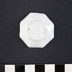 Underside of white ceramic octagonal plate.