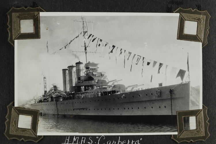 Military ship with flags on display.