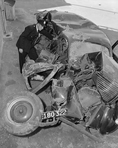 Policeman Inspecting Car Accident, Melbourne, Victoria, 1953::Laurie Richards Collection