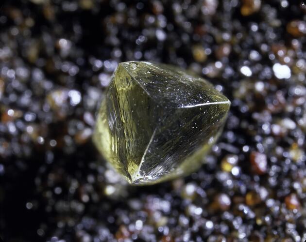 Uncut yellowish diamond.
