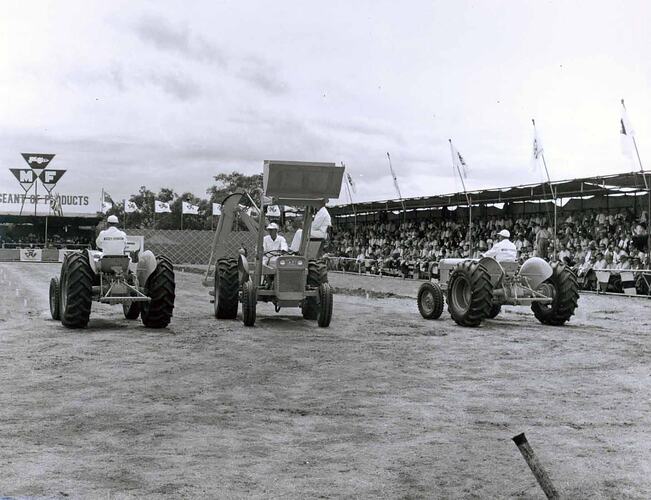 Farm equipment on display in front of grandstand.