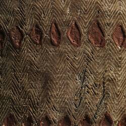 Detail of diamond pattern on wooden shield.