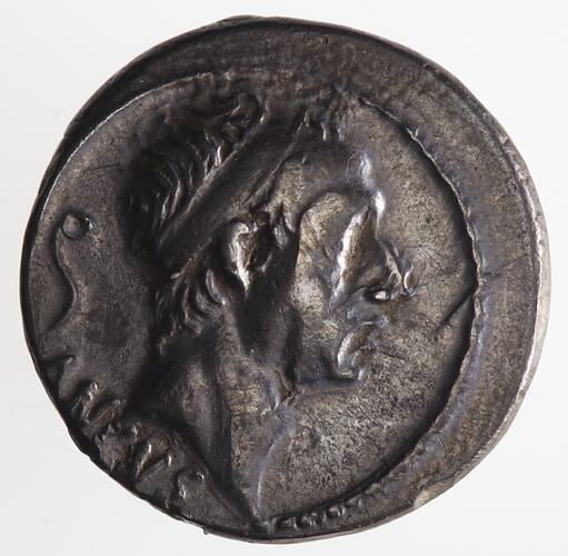 Round coin, aged, male profile, facing right, wearing headdress.