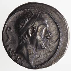 Round coin, aged, male profile, facing right, wearing headdress.