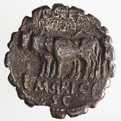 Round coin, aged, figure with oxen, going to the left.