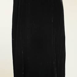 Black ankle length cloak on mannequin, back view.