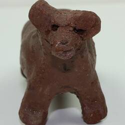Toy dog made from clay, front view.