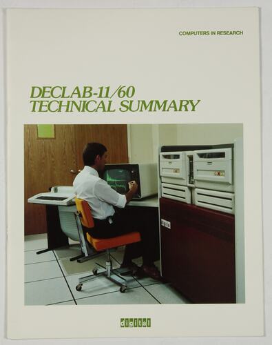 White brochure cover with colour photo of man sitting at computer desk. Green text above and below.