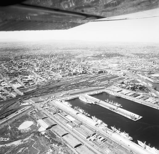 Monochrome aerial image of a shipping dock.