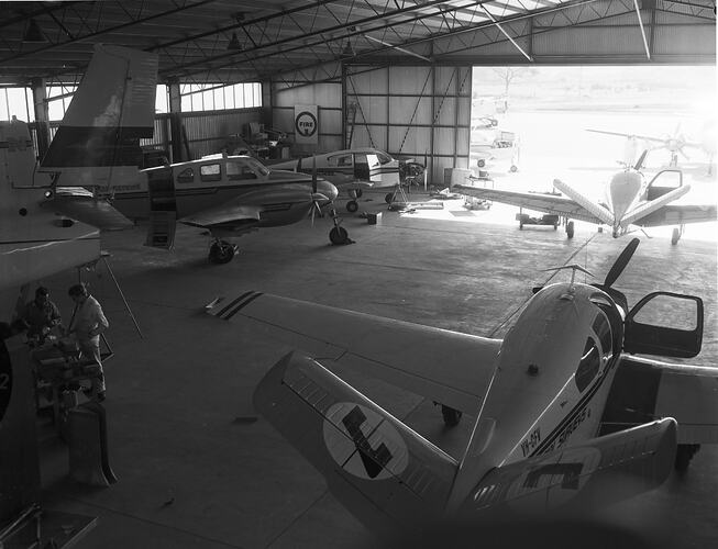 Monochrome image of an aircraft hangar.