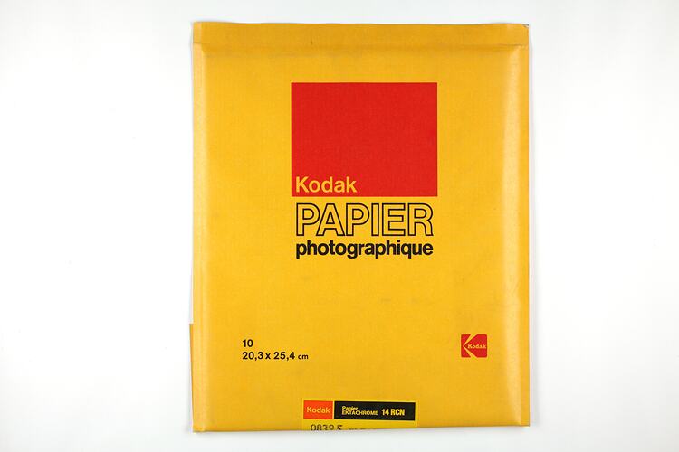Yellow paper packet with red and black text.