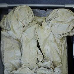 Cream dress showing upper back detail.