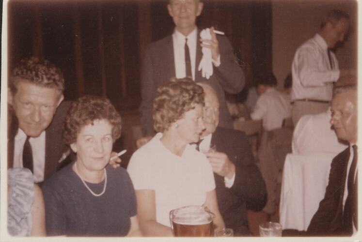 Men and women drinking and talking.